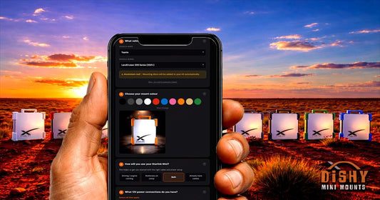 Hand holding phone showing Starlink Mini Kit Builder app with coloured mounts lined up in outback sunset