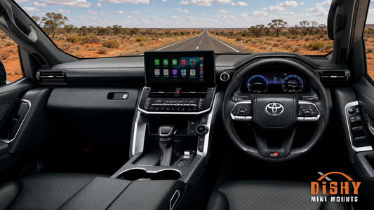 View from the driver's seat of a four wheel drive on an outback highway, dash and centre console in view