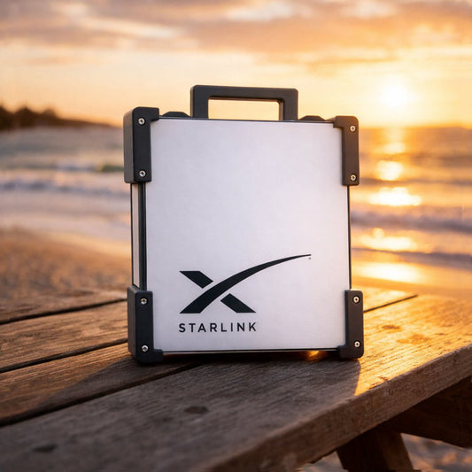 Black Starlink Mini Magnetic Mount on timber table at Australian beach sunset - portable satellite dish carry frame by Dishy Mini Mounts