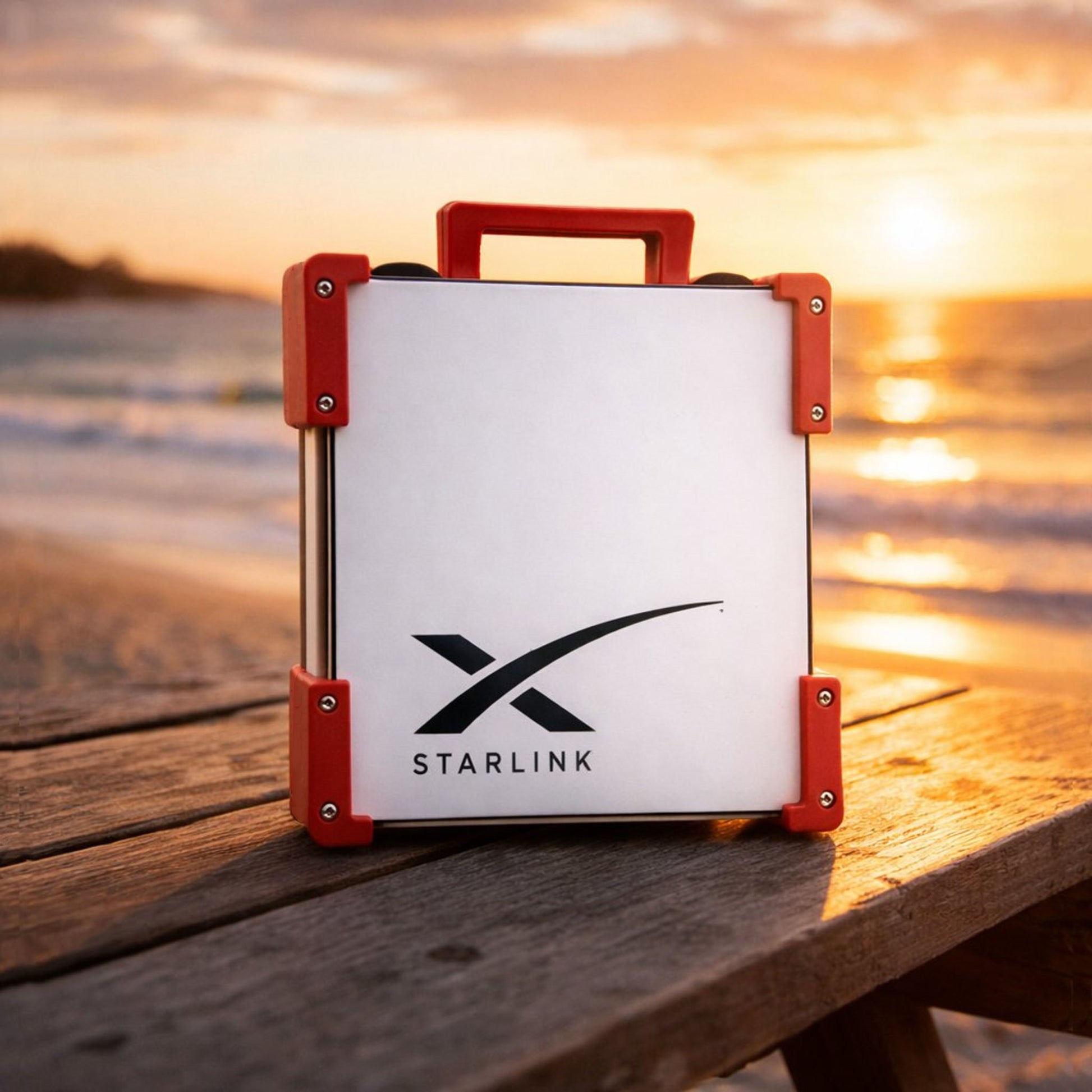 Red Starlink Mini Magnetic Mount on timber table at Australian beach sunset - portable satellite dish carry frame by Dishy Mini Mounts