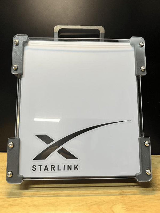 Starlink device packaging on a wooden surface with a dark background