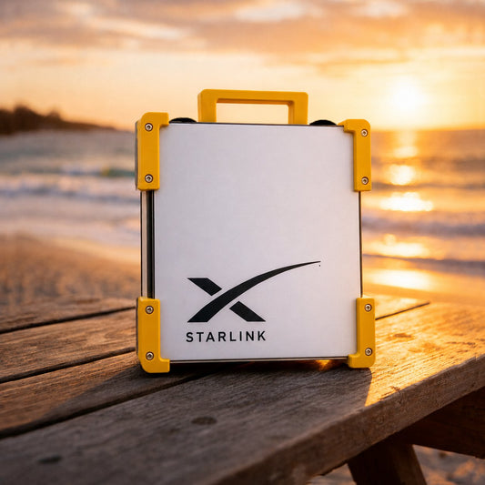 Yellow Starlink Mini Magnetic Mount on timber table at Australian beach sunset - portable satellite dish carry frame by Dishy Mini Mounts