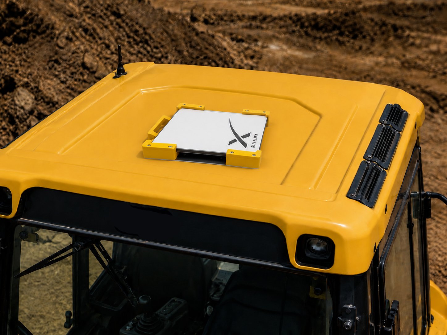 Yellow Starlink Mini mount fitted to the roof of a yellow machine cab on an earthmoving site - Dishy Mini Mounts high-vis machinery mount
